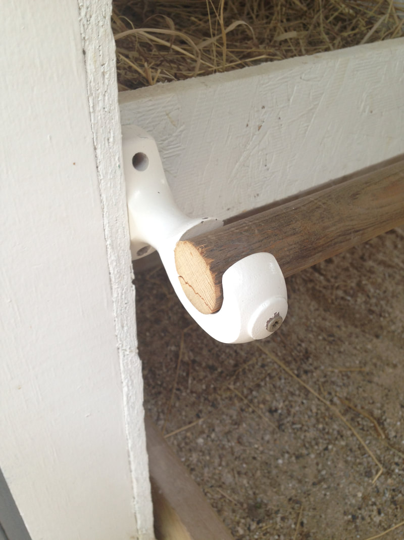 We used cheap curtain rod holders for our nesting box coop.